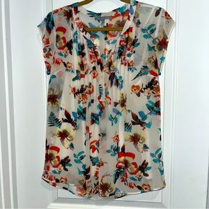 White sheer blouse with bright floral pattern with camisole to wear underneath
